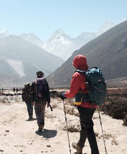 Image of hikers walking a mountain path in Nepal - KILROY