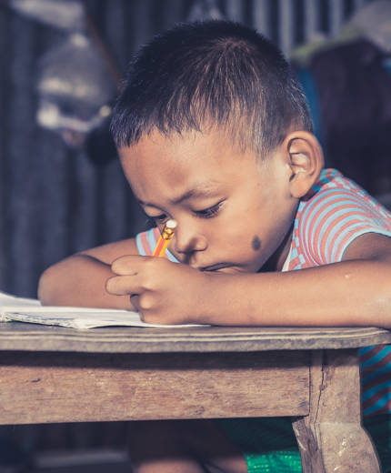 Image of Thai child doing homework - KILROY