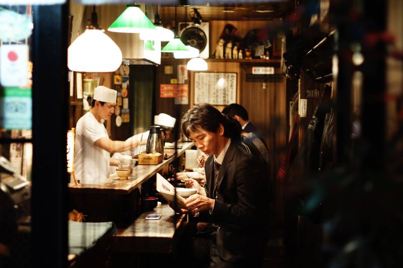 Image of Japanese businessmen eating at a traditional Japanese Inn - KILROY