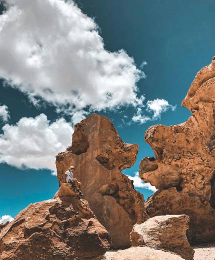 Image of a male traveller on a rock formation in Potosi in Bolivia - KILROY