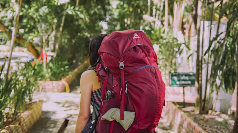 Image of young female traveller wearing a backpack - KILROY