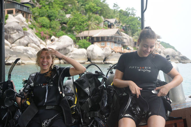 Two girls on a boat in Thailand smiling after taking a dive in the waters of Koh Tao